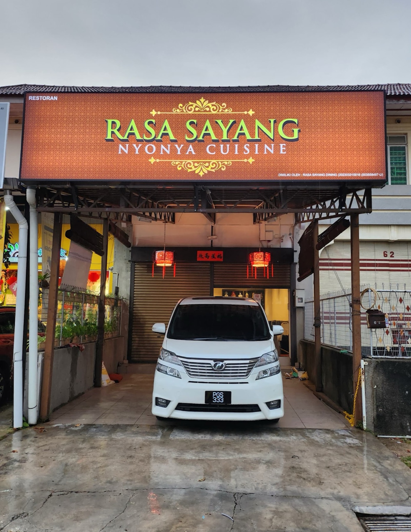 The Rasa Sayang Nyonya Cuisine signboard in emerald and gold above the Jalan Moulmein shopfront