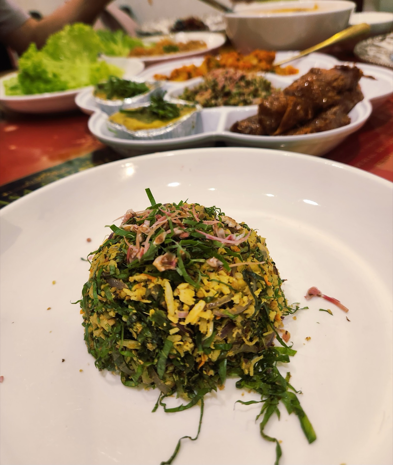 Jiu hu char — finely shredded turnip and cuttlefish herb salad mounded on a white plate